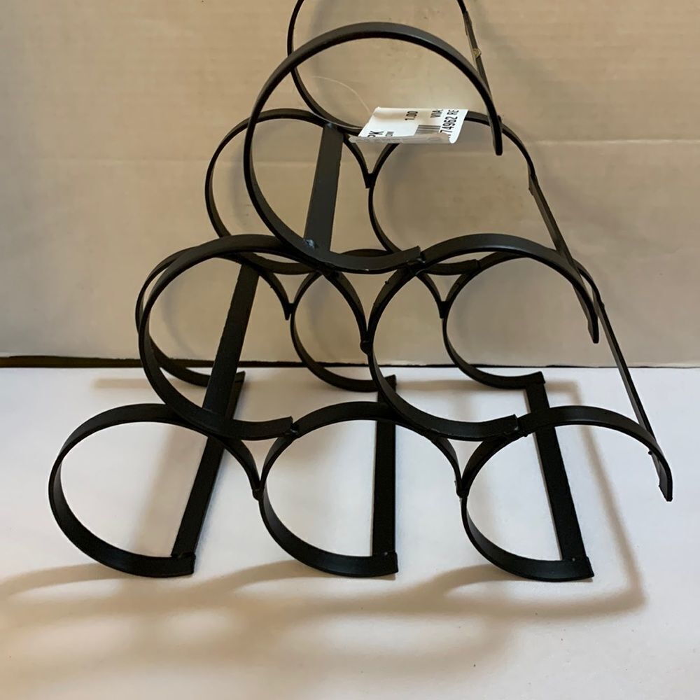 Black metal wine bottle holder. Holds six bottles